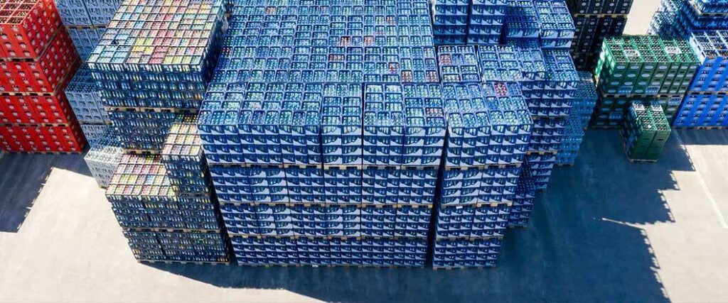 Several cases of liquor stacked at port on pallets. 