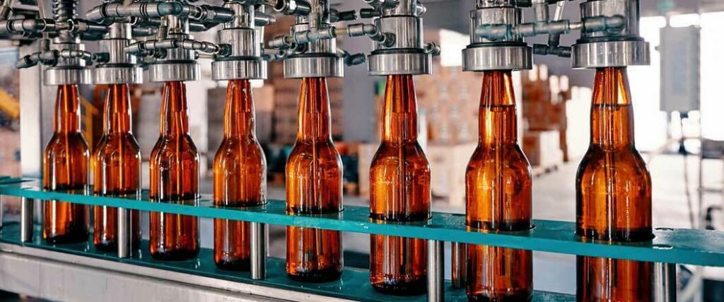 A bottling conveyor belt being used to bottle 12-ounce beers.