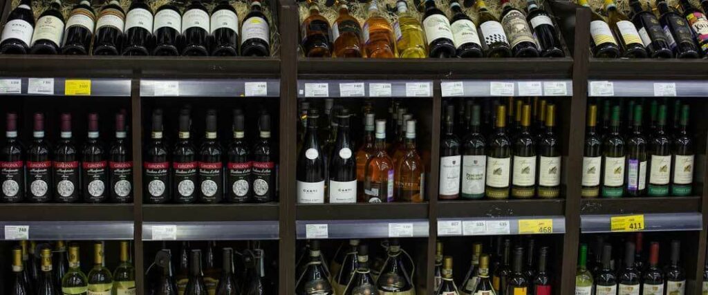 Several brands of wine on display in a liquor store.