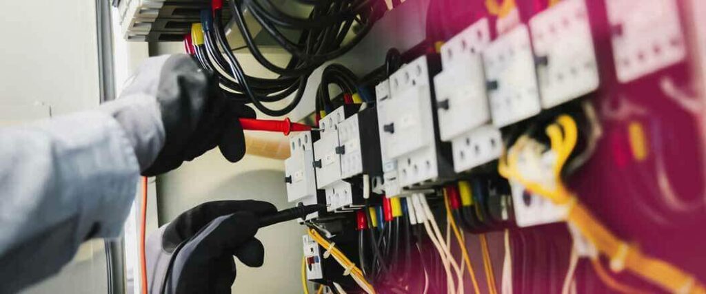 A worker inspecting wiring