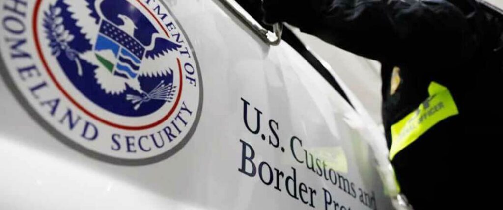 A CBP worker at the window of a CBP truck