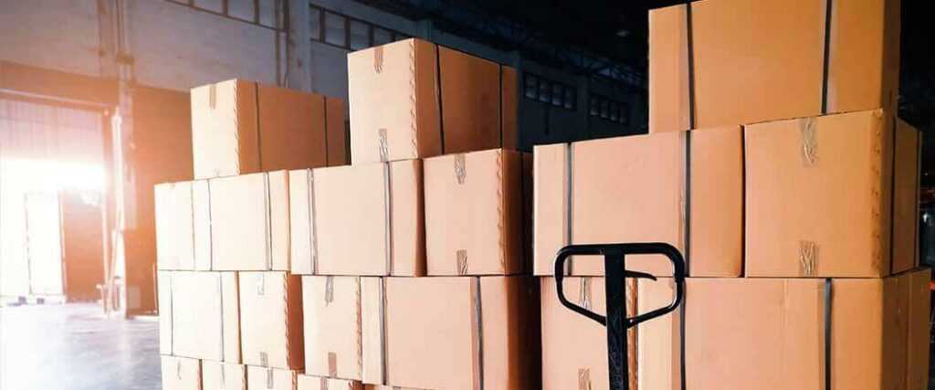 Palletized freight and a pallet jack in a warehouse