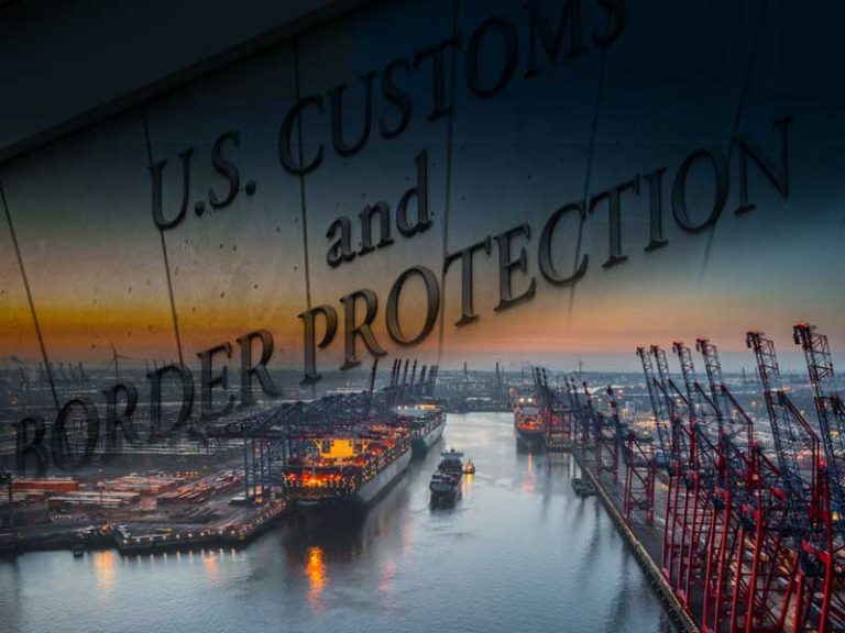 An overheard view of an ocean port in the evening, with the phrase "US Customs and Border Protection" superimposed over the scene.