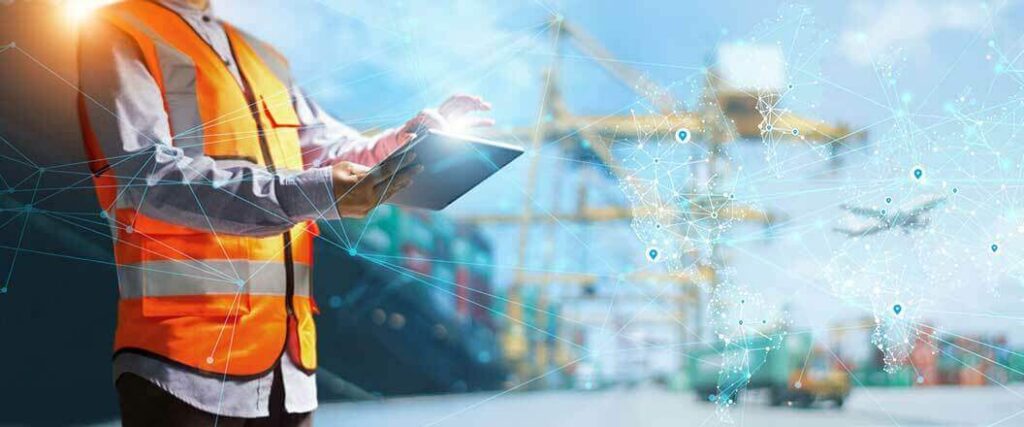 A port worker on a touchscreen device in a container port