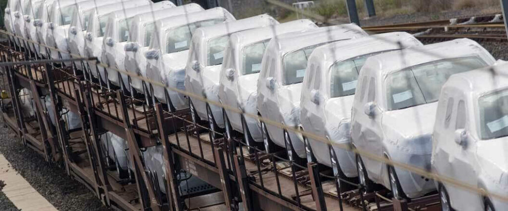 Cars in protective covering on a train