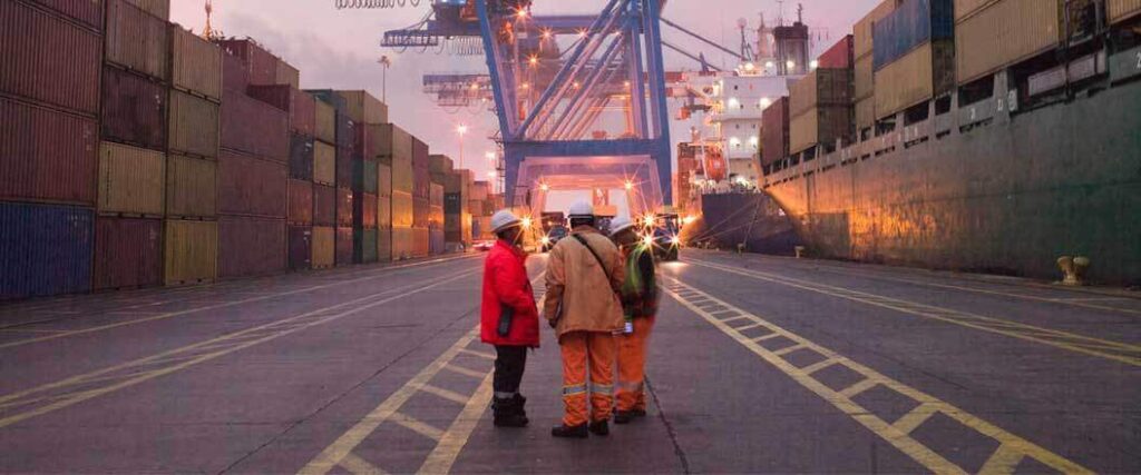 Dock workers at a cargo port ready to accept imports