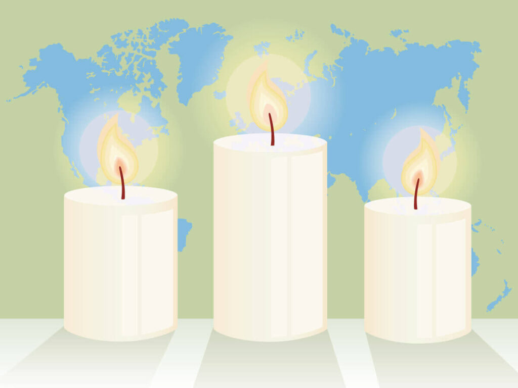 Three candles with a map of the world in the background