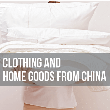 A person holding pillows and blankets