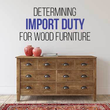 A wooden chest of drawers sits against a wall