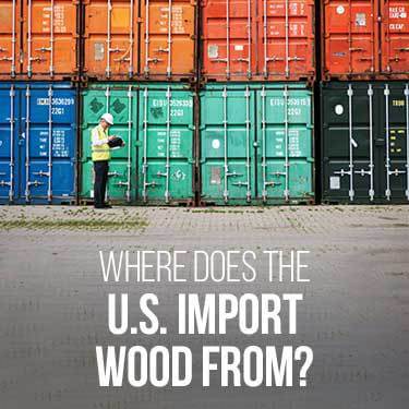 A man stands in front of shipping containers