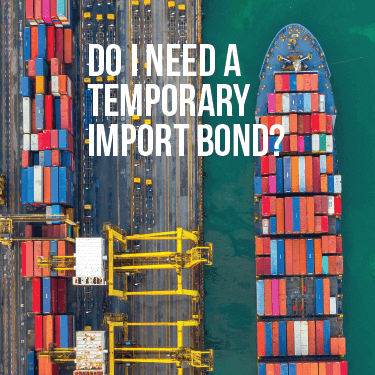 Aerial view of a cargo ship being loaded with containers