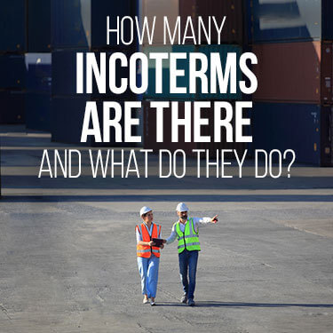 Two port workers walking through a port while discussing the importance of incoterms.