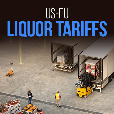 Pallets are loaded into the back of a truck using a forklift