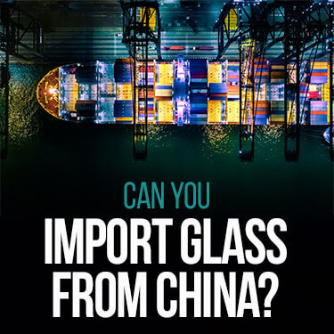 Importing glass from China - An aerial shot of a cargo ship lit up at night