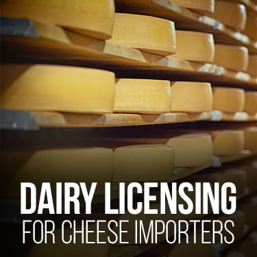 cheese wheels on aging racks