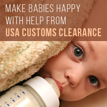 close up of baby in a blanket drinking from a bottle