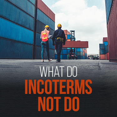 Two longshoreman walking past stacks of cargo containers
