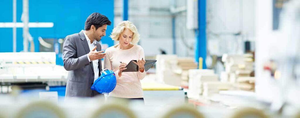 man and woman reviewing a checklist