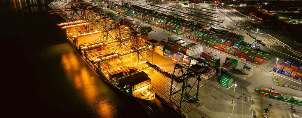 containership being loaded at night with lights on