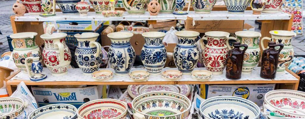 Ceramic vases and bowls sitting on shelves
