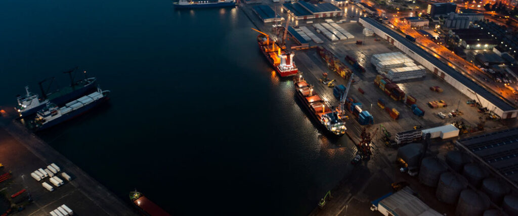 birds eye view of harbor with two container ships docked
