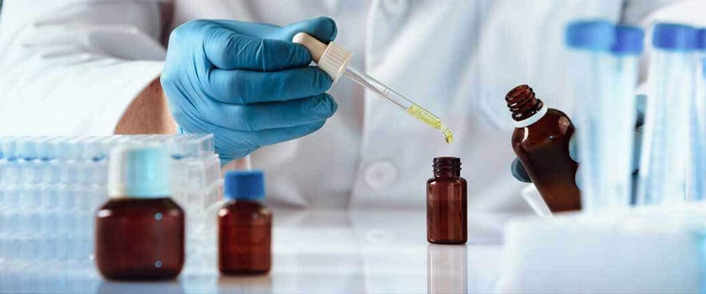 importing perfume to usa lab worker using a dropper to add liquid to a small bottle