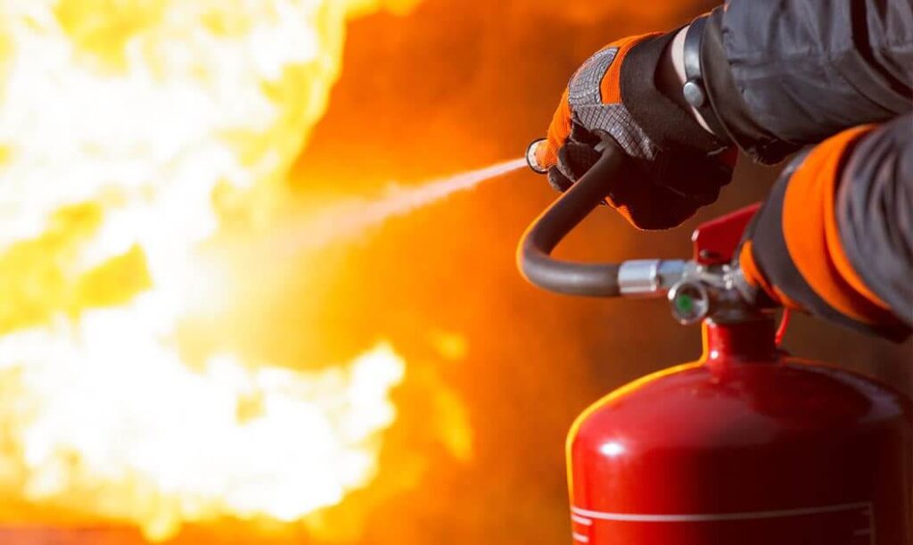 fire extinguisher being used on an open flame