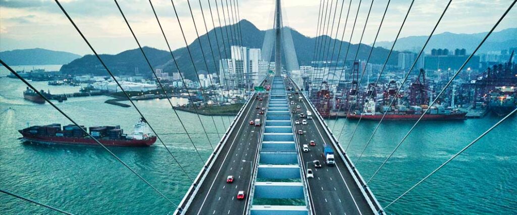 Vehicles traveling back and forth on a suspension bridge. 