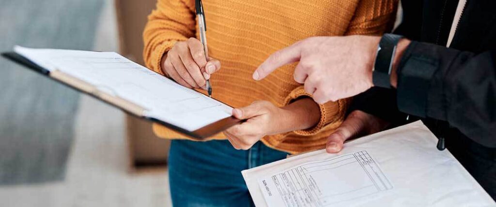 Two individuals reviewing customs paperwork.