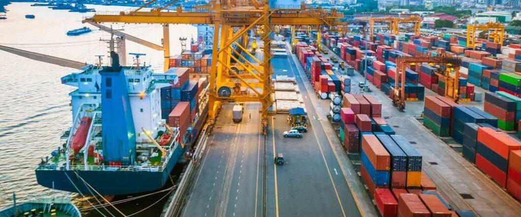 Ships docked at port waiting to be loaded with cargo containers.