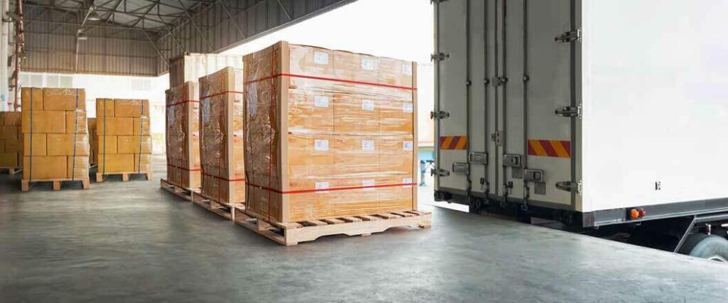 Palletized cargo on a loading dock waiting for a semi truck.