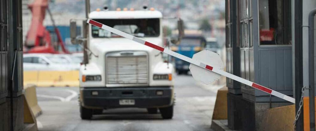 A semi truck pulling up exit of a port
