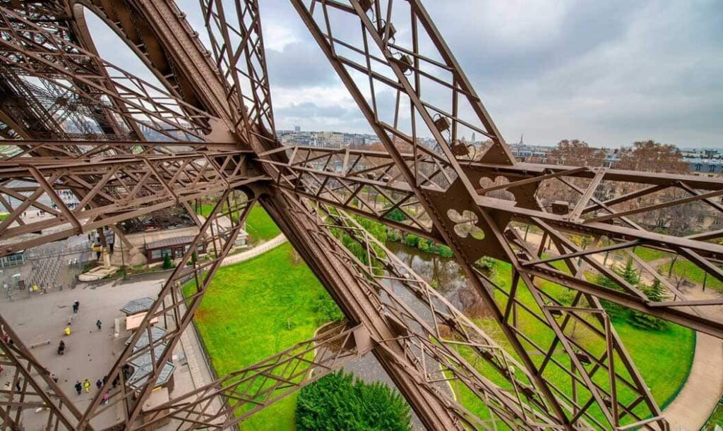 A view of the Champ de Mars from within the Eiffel Tower.