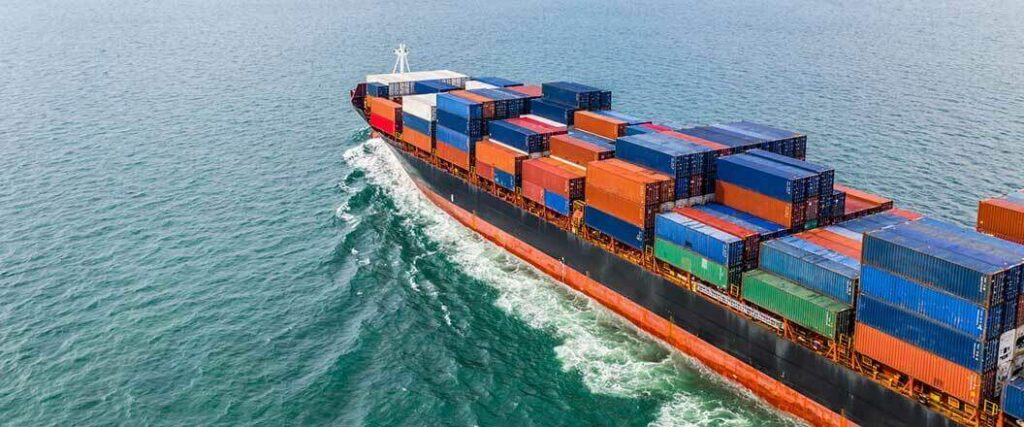 Importer of record vs consignee: each of these parties requires the services of cargo vessels such as the loaded vessel seen here at sea.