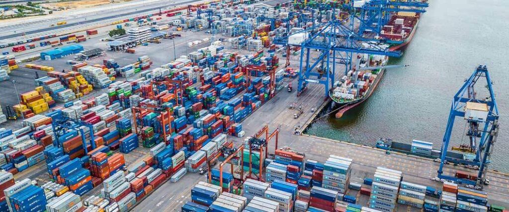 An isometric view of hundreds of shipping containers stacked at port.