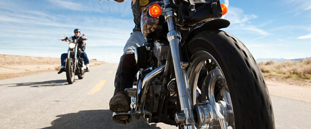 Two motorcyclists on a highway.