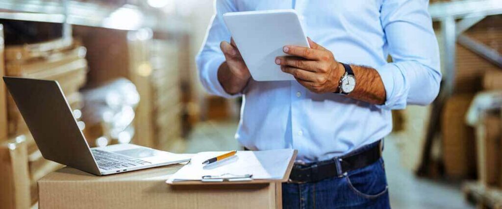 How to get an import export license, man checks a list on a tablet.