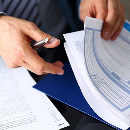 Importing Motorcycles - Professional thumbing through documents