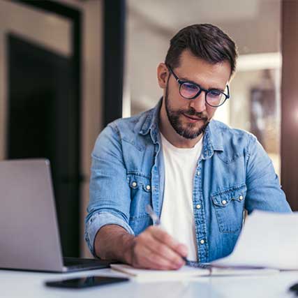 Importing Personal Items - Man writing in notebook