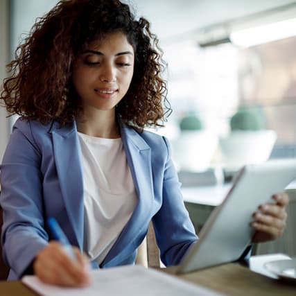 Woman writing on document