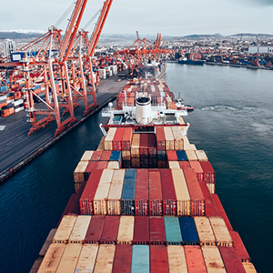 Embark on your importing journey with confidence - Image of shipping vessel at a port