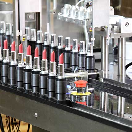 Learn the Ins and Outs of Importing Cosmetics - Row of lipstick along manufacturing line