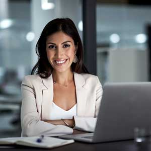 Need a more hands-on approach - Image of woman at a desk with laptop