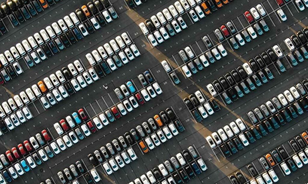 An aerial view of a parking lot full of cars