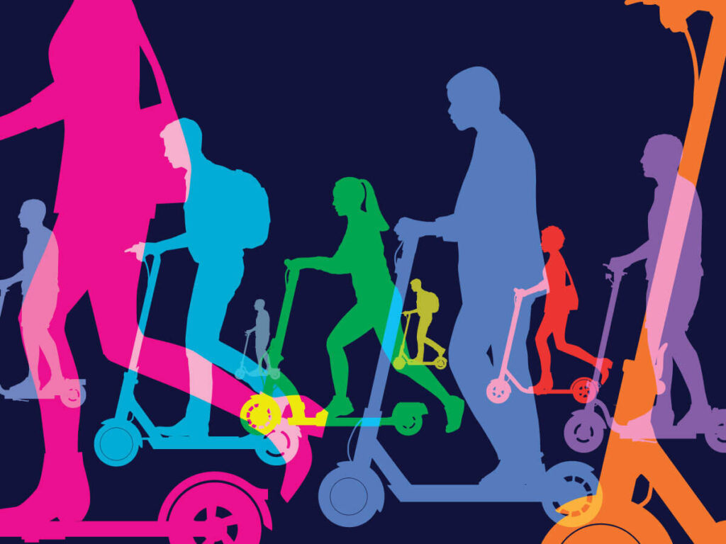 Numerous people riding on electric scooters