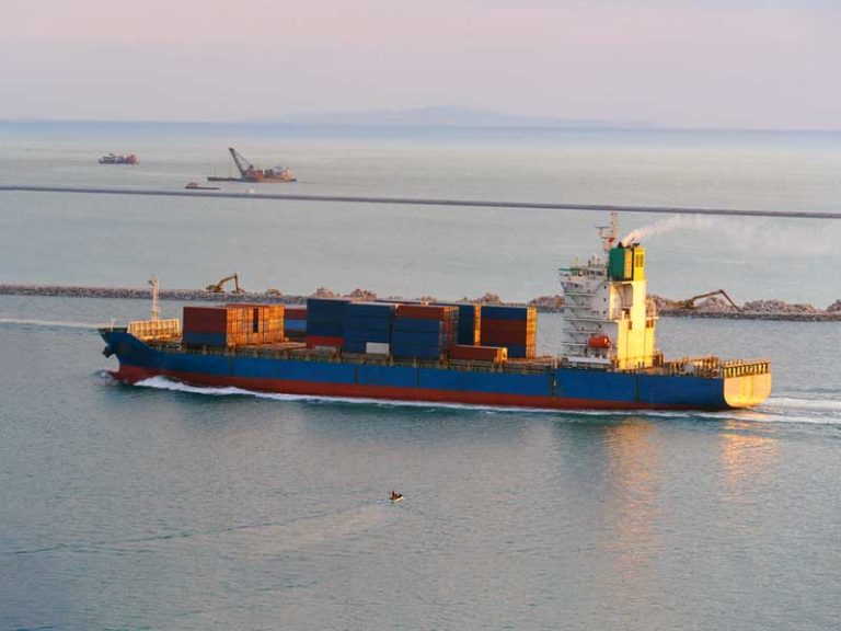 A cargo ship bringing in containers to a port. This image is relevant, because many entry types travel aboard a vessel.